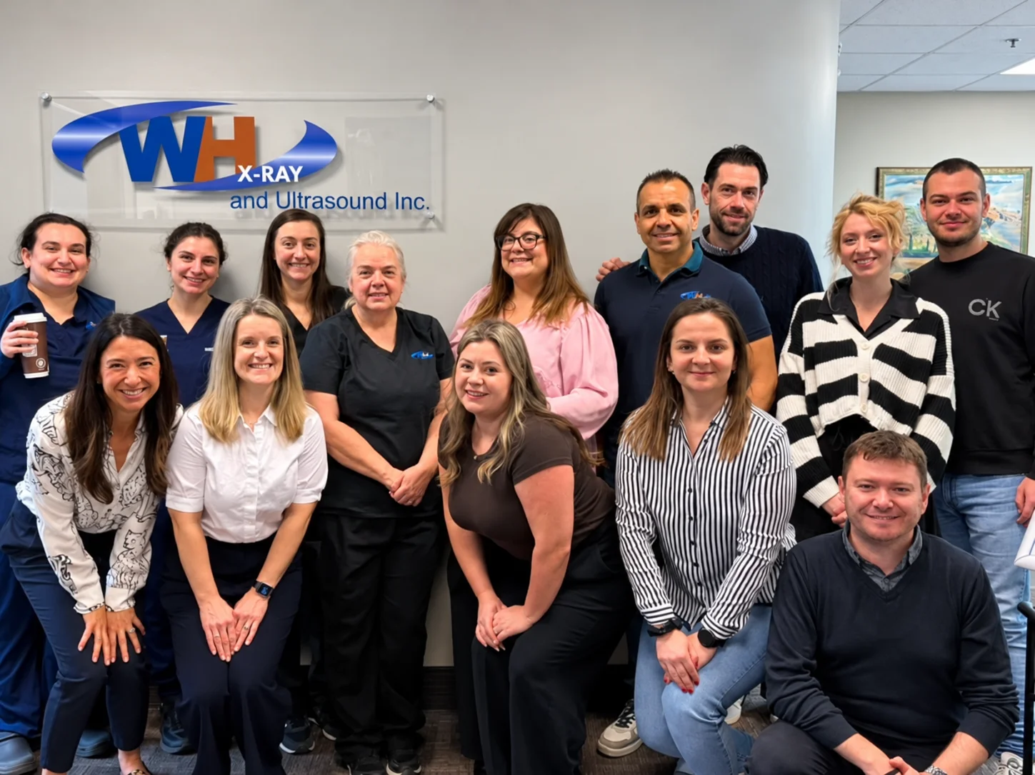 The Wentworth-Halton X-Ray and Ultrasound team with the Sorsix team, in front of the Wentworth-Halton logo